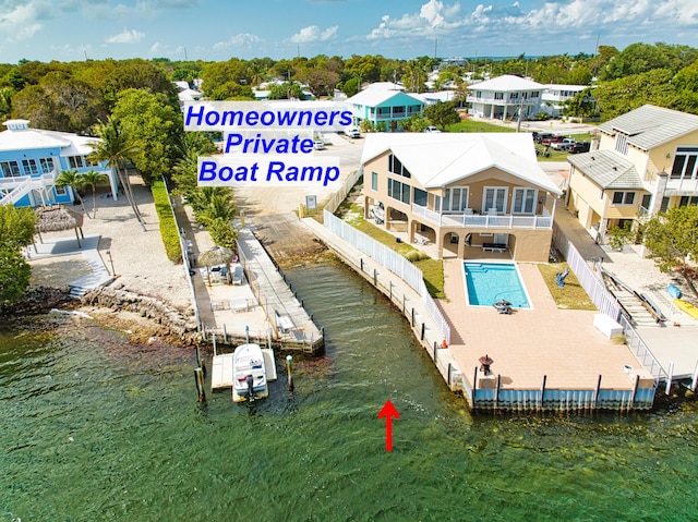 drone / aerial view featuring a residential view and a water view