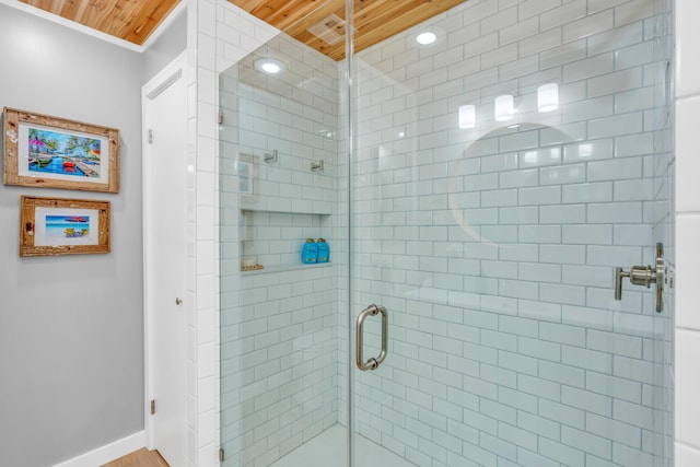 bathroom featuring a shower with door and wooden ceiling