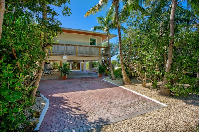 back of property with a carport