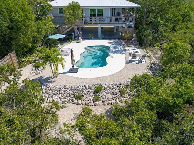 view of swimming pool featuring a deck and a patio