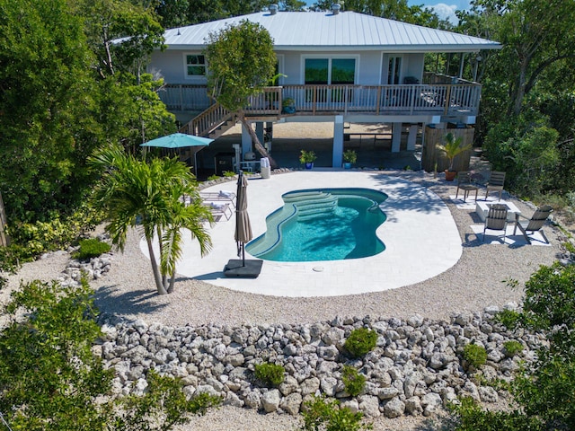 view of pool featuring a wooden deck and a patio area