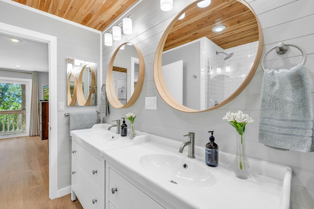 bathroom featuring vanity, hardwood / wood-style flooring, wooden ceiling, and a shower