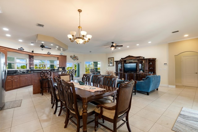 dining space featuring sink, ceiling fan with notable chandelier, ornamental molding, and light tile patterned flooring