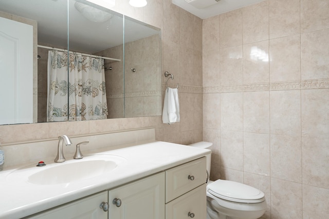 bathroom featuring a shower with curtain, vanity, toilet, and tile walls