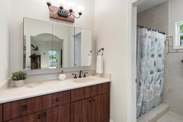 bathroom featuring vanity and curtained shower