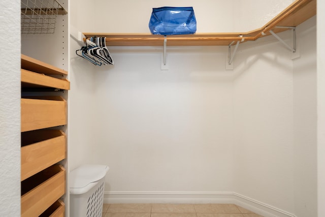 spacious closet featuring light tile patterned flooring