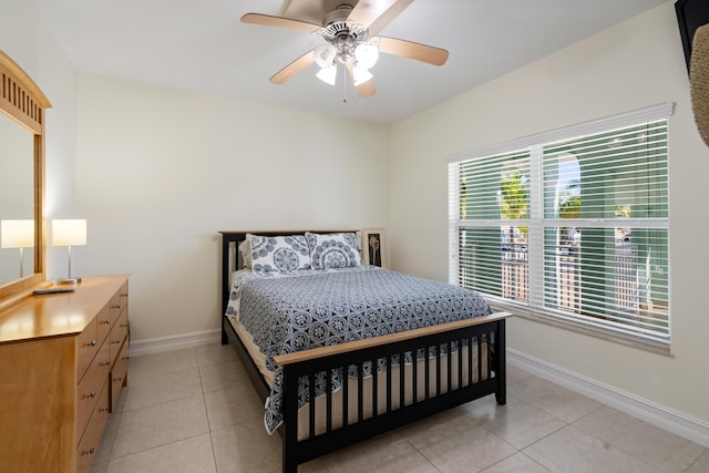 tiled bedroom featuring ceiling fan