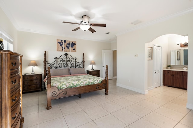 bedroom with light tile patterned floors, crown molding, ceiling fan, and ensuite bathroom