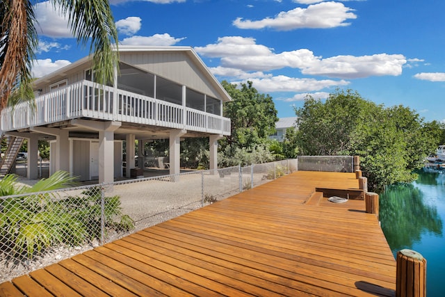 exterior space featuring a sunroom and a water view