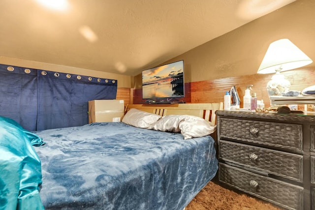 carpeted bedroom with vaulted ceiling and a textured ceiling