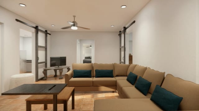 living room with light tile patterned floors, a barn door, and ceiling fan