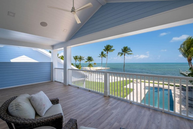 wooden deck featuring a ceiling fan, a water view, an outdoor pool, and an outdoor hangout area