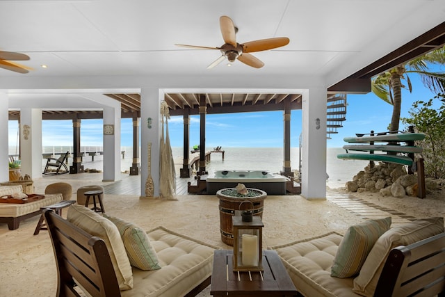 view of patio featuring a water view, an outdoor hangout area, and a jacuzzi