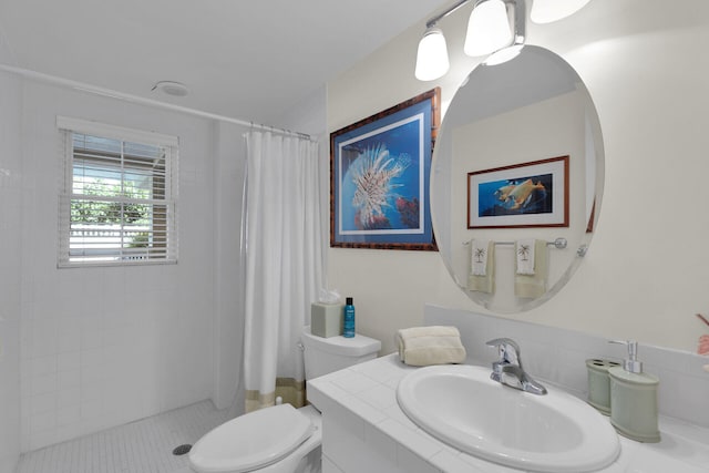 bathroom with a shower stall, toilet, and vanity