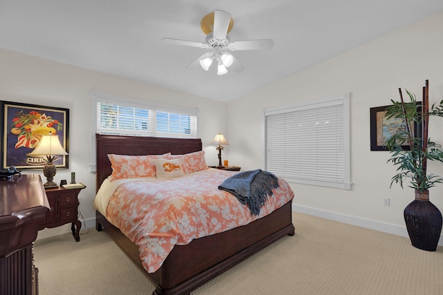 bedroom with baseboards, light carpet, ceiling fan, and vaulted ceiling