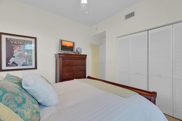 bedroom with visible vents, a closet, and a ceiling fan