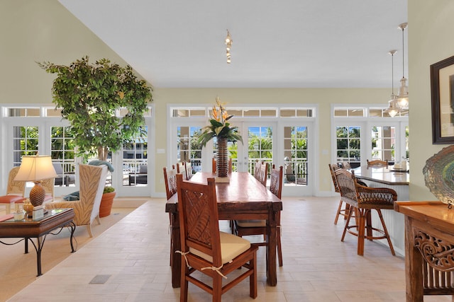 dining area featuring light wood-type flooring, french doors, and baseboards