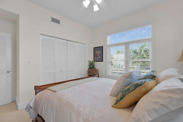 bedroom featuring visible vents, a closet, carpet floors, baseboards, and ceiling fan