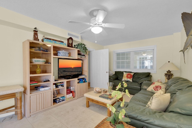 living area with visible vents, ceiling fan, and light tile patterned flooring