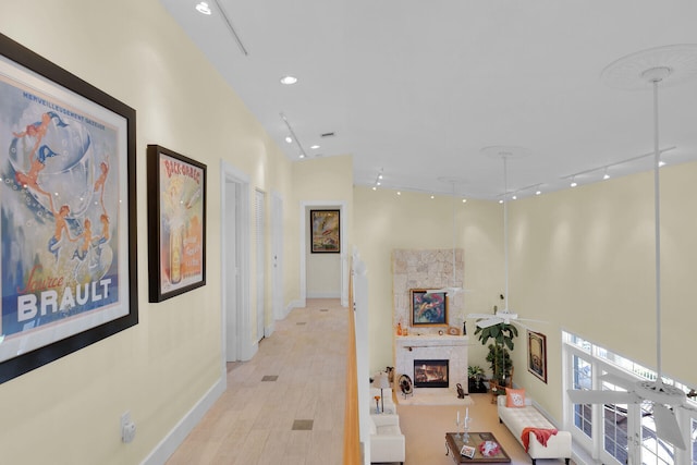 hallway with recessed lighting, baseboards, light wood-style floors, and track lighting