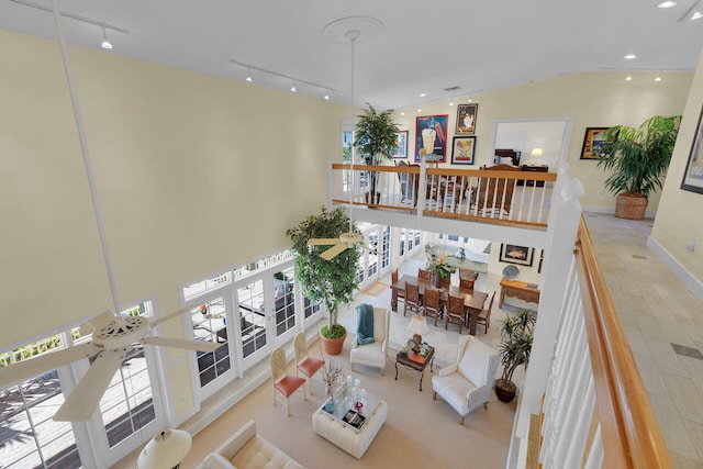 living room featuring track lighting, recessed lighting, french doors, and baseboards