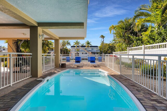 view of swimming pool with a fenced in pool and a fenced backyard