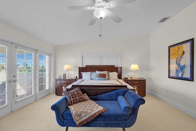 bedroom featuring access to exterior, light colored carpet, visible vents, and baseboards