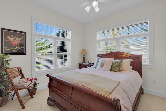 bedroom featuring a ceiling fan, baseboards, and light carpet