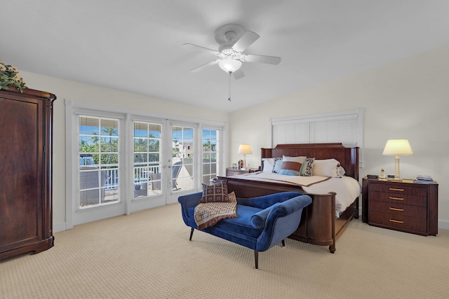 bedroom featuring access to exterior, light carpet, ceiling fan, and vaulted ceiling