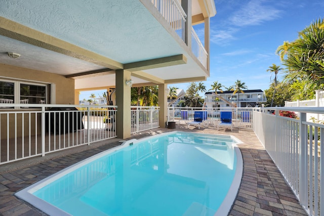 view of swimming pool featuring fence