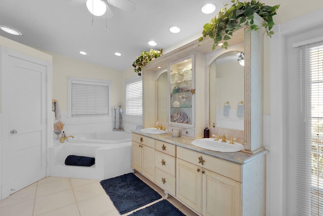 full bathroom with a sink, double vanity, a ceiling fan, and tile patterned floors