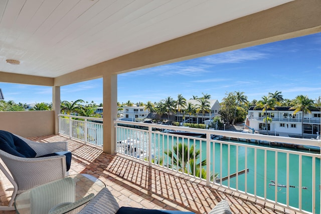 balcony featuring a water view and a residential view