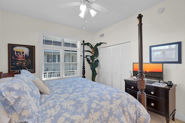 carpeted bedroom featuring a closet, visible vents, and ceiling fan