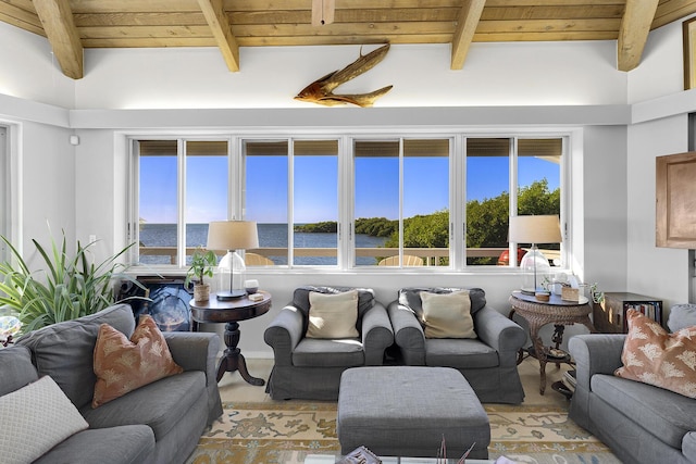 living area with wooden ceiling, a water view, and beam ceiling