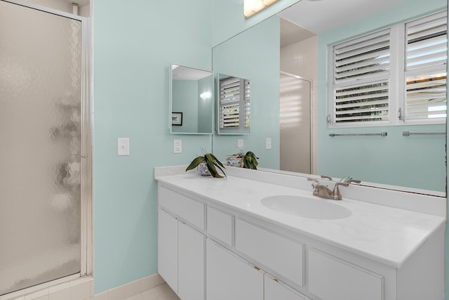 bathroom with a stall shower and vanity