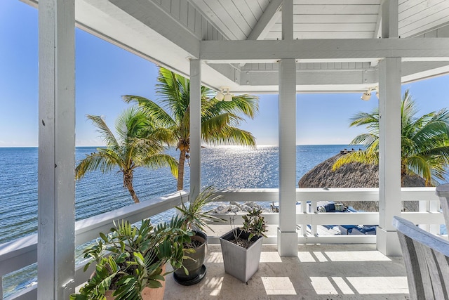 sunroom / solarium with a water view