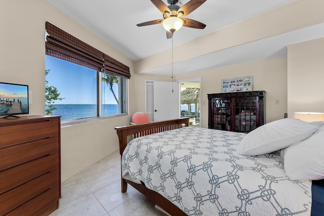 bedroom with a water view, ceiling fan, lofted ceiling, and light tile patterned flooring