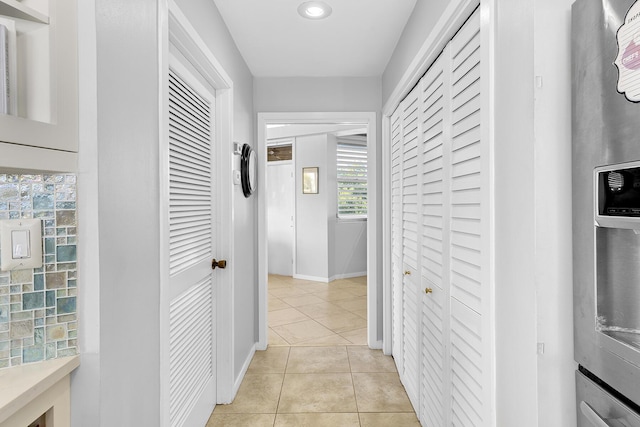 corridor featuring light tile patterned floors