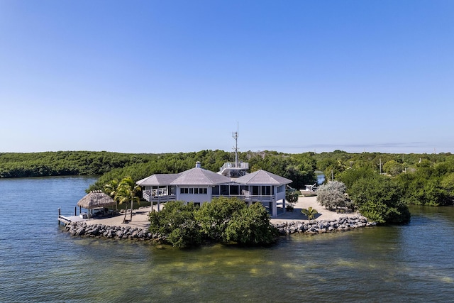 exterior space with a water view and a view of trees