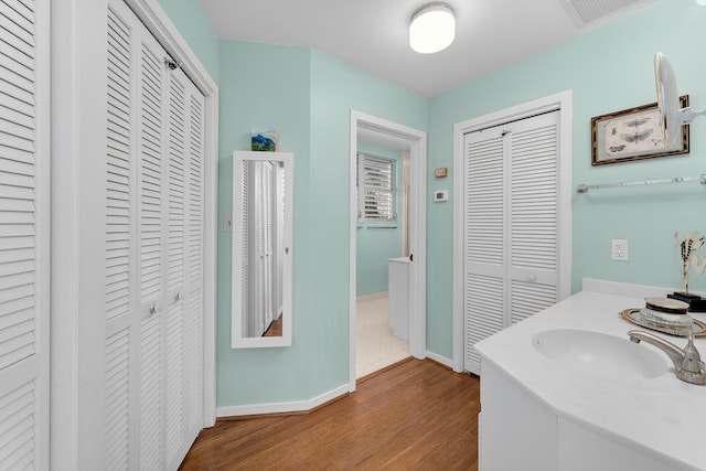 full bath with a closet, visible vents, and wood finished floors