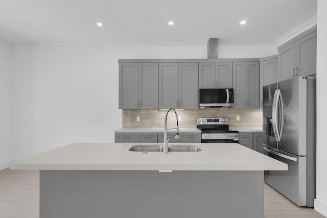 14 Tarpon Ave, Key Largo, FL 33037 - kitchen with appliances with stainless steel finishes, gray cabinets, ornamental molding, backsplash, and light wood finished floors