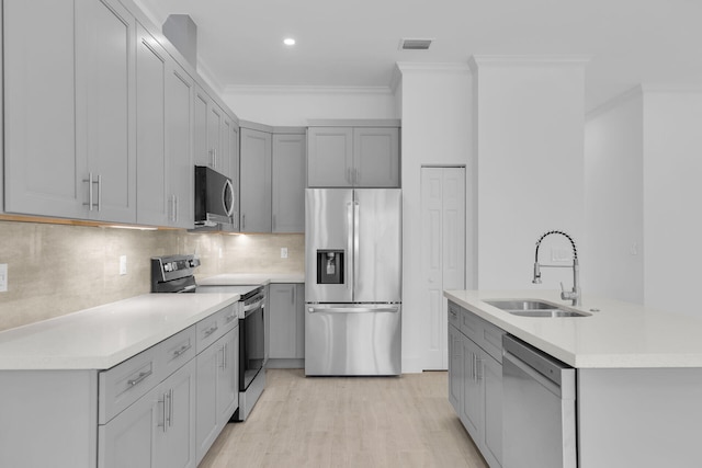 14 Tarpon Ave, Key Largo, FL 33037 - kitchen with stainless steel appliances, gray cabinetry, ornamental molding, and recessed lighting