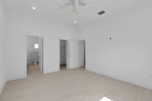 14 Tarpon Ave, Key Largo, FL 33037 - unfurnished bedroom featuring light wood-style flooring, a walk in closet, recessed lighting, ensuite bathroom, and a closet