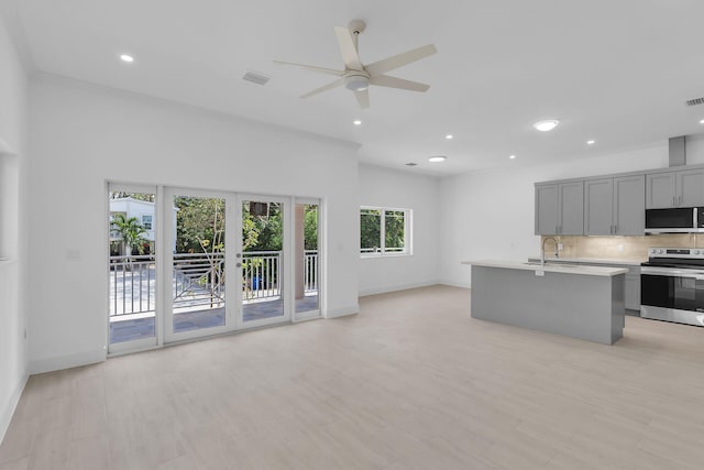 14 Tarpon Ave, Key Largo, FL 33037 - kitchen featuring stainless steel range with electric stovetop, gray cabinets, open floor plan, light countertops, and backsplash