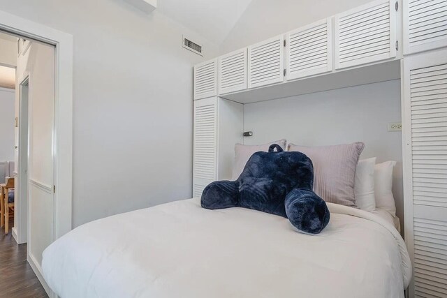 817 Terry Ln, Key West, FL 33040 - bedroom with lofted ceiling, visible vents, and dark wood finished floors