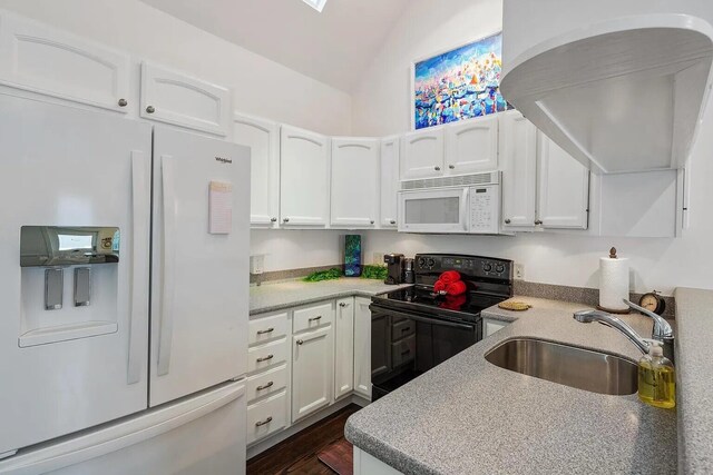 817 Terry Ln, Key West, FL 33040 - kitchen with white appliances, white cabinets, vaulted ceiling, light countertops, and a sink