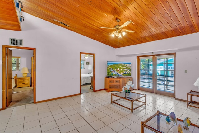 living room featuring vaulted ceiling, plenty of natural light, and light tile patterned floors