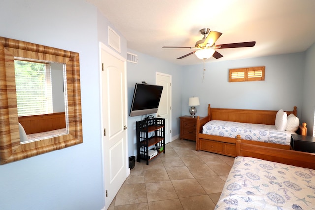 bedroom with light tile patterned floors, baseboards, visible vents, and a ceiling fan