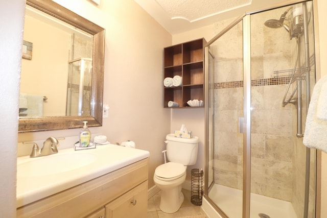 full bath with a stall shower, vanity, toilet, and tile patterned floors