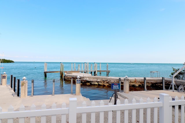 dock area featuring a water view and fence